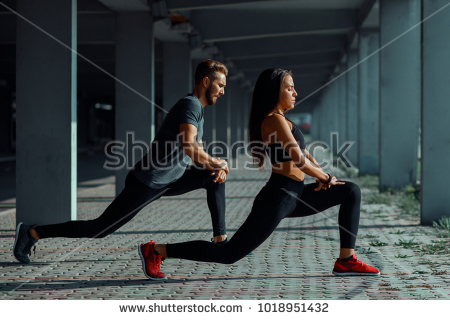 stock-photo-young-couple-stretching-legs-in-urban-environment-1018951432.jpg