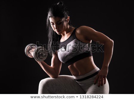 sporty-muscular-woman-dumbbell-on-450w-1318284224.jpg