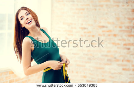 stock-photo-young-happy-woman-measuring-her-waist-with-a-tape-measure-at-home-indoors-caucasian-model-in-553049365.jpg