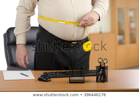 standing-man-measures-his-waist-450w-396446176.jpg