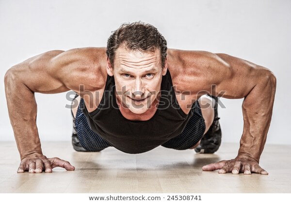 middleaged-muscular-man-doing-pushup-600w-245308741.jpg