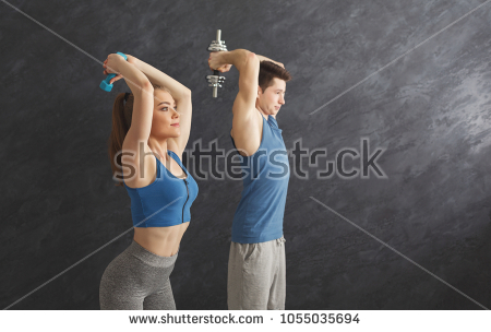 stock-photo-strong-fitness-couple-training-with-dumbbells-at-gym-doing-strength-exercise-for-biceps-1055035694.jpg