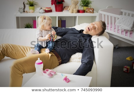 tired-father-sleeping-baby-on-450w-745093990.jpg