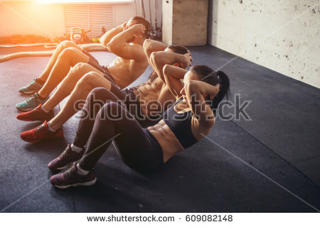 stock-photo-group-of-athletic-adult-men-and-women-performing-sit-up-exercises-to-strengthen-their-core-609082148.jpg