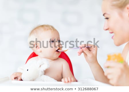 mother-feeding-baby-spoon-450w-312688067.jpg