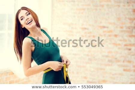 young-happy-woman-measuring-her-450w-553049365.jpg
