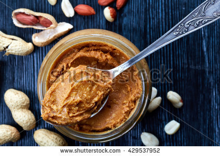 stock-photo-jar-and-spoon-of-peanut-butter-and-peanuts-on-dark-wooden-background-from-top-view-429537952.jpg