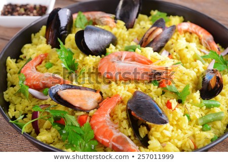 seafood-paella-pan-closeup-450w-257011999.jpg