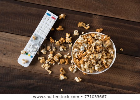 caramel-popcorn-tv-remote-on-450w-771033667.jpg