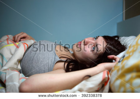 stock-photo-young-woman-lying-in-bed-suffering-with-insomnia-noisy-neighbour-stress-alarm-sound-prevent-392338378.jpg