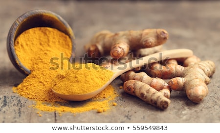 turmeric-powder-fresh-on-wooden-450w-559549843.jpg