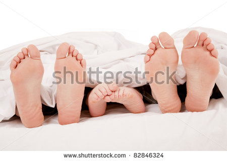 stock-photo-a-close-up-of-a-family-showing-off-their-feet-under-the-covers-82846324.jpg