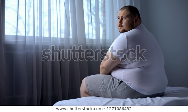 sad-fat-man-sitting-on-600w-1271086432.jpg